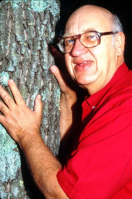 Alex Shigo beside a tree